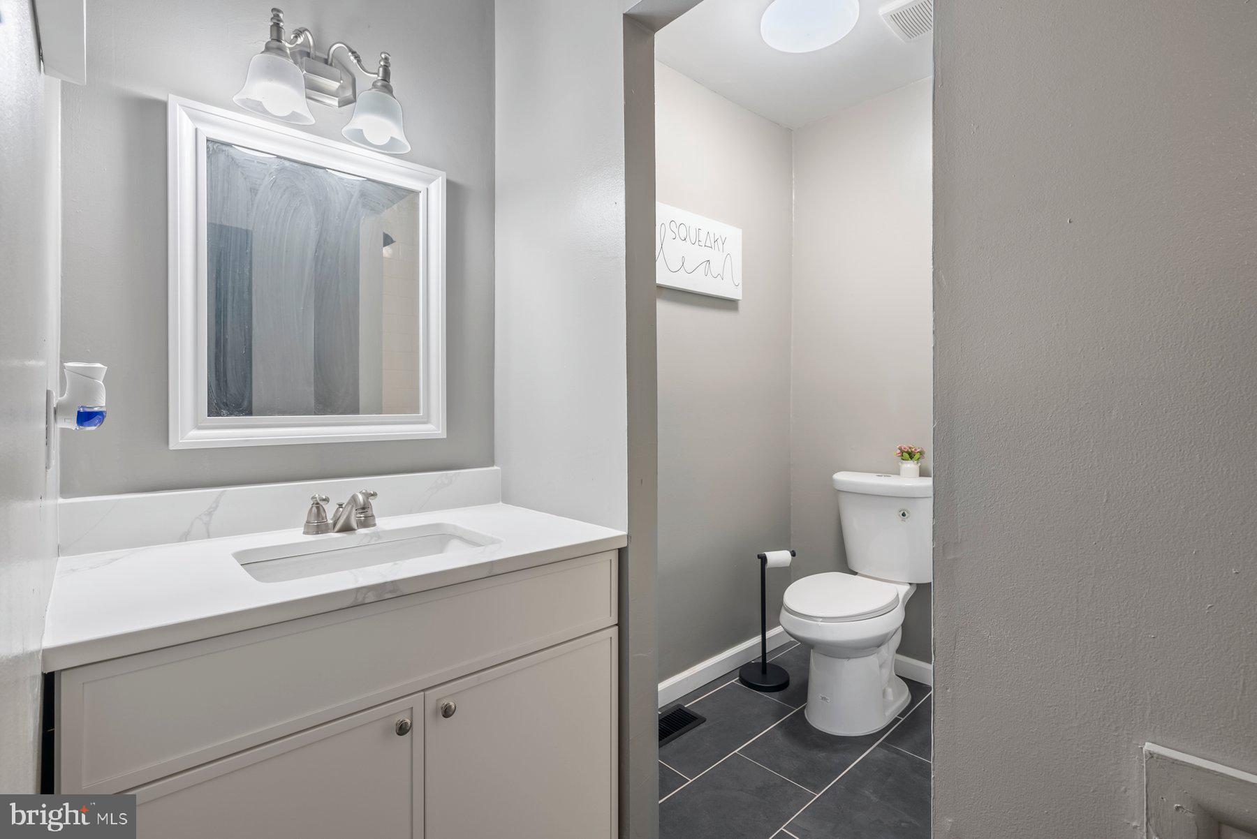 261 Via Cascata Drive Clementon, NJ 08021 - Photo 14 of 26 a bathroom with a toilet sink vanity and mirror