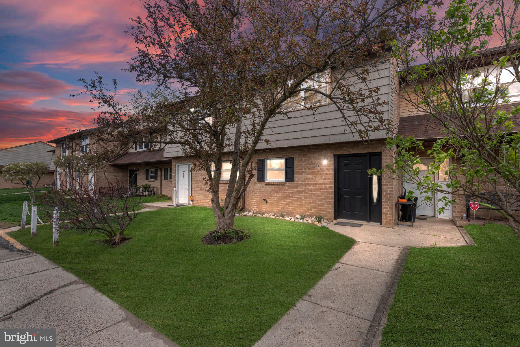 261 Via Cascata Drive Clementon, NJ 08021 - Photo 2 of 26 a front view of a house with a garden and trees