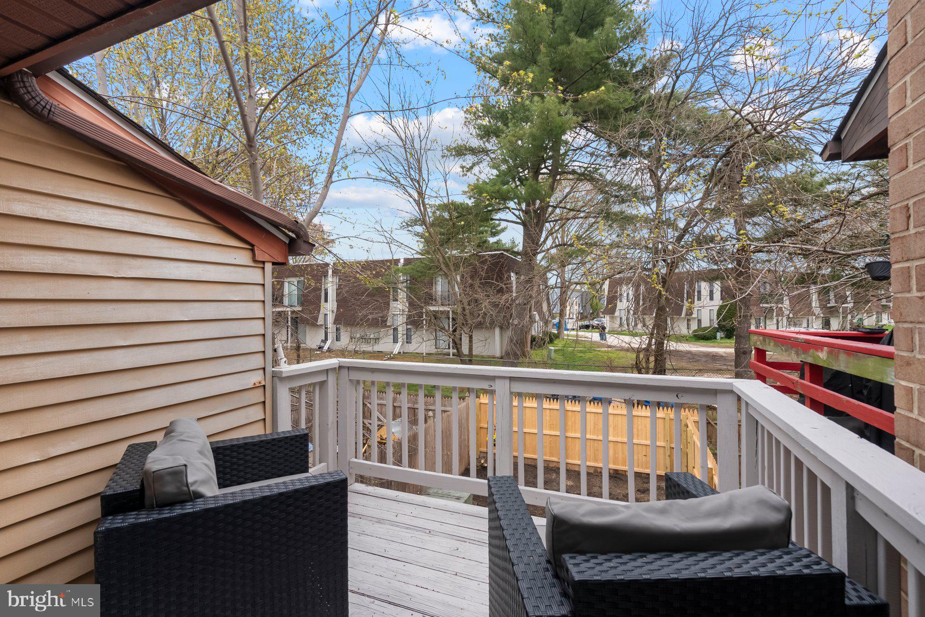261 Via Cascata Drive Clementon, NJ 08021 - Photo 21 of 26 a view of a balcony with chairs and wooden fence