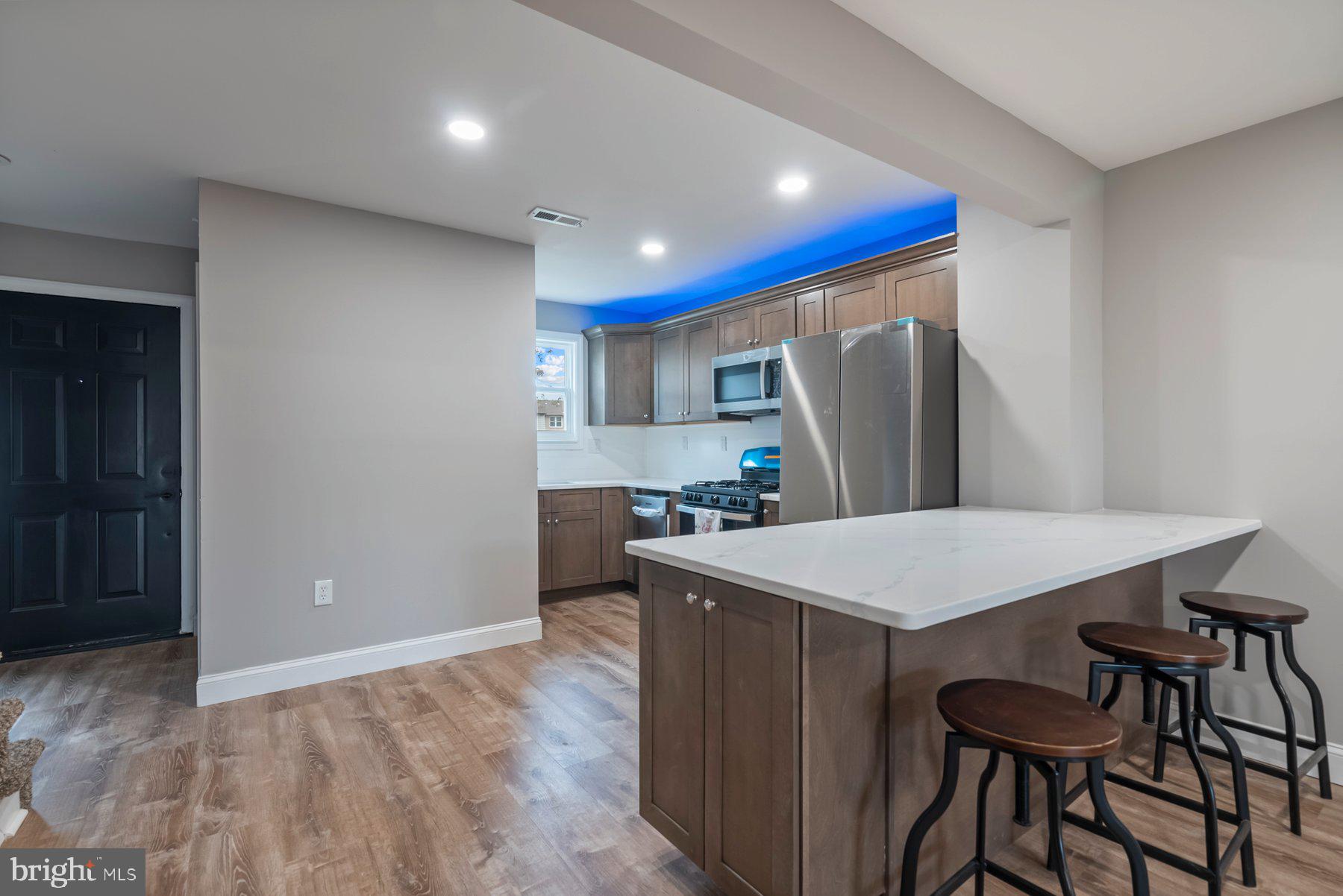 261 Via Cascata Drive Clementon, NJ 08021 - Photo 6 of 26 a kitchen with stainless steel appliances granite countertop a refrigerator a sink a stove a dining table and chairs