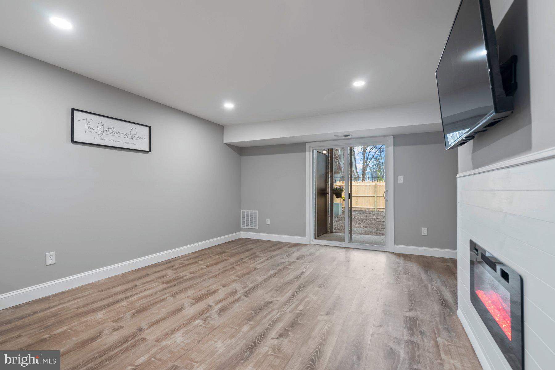 261 Via Cascata Drive Clementon, NJ 08021 - Photo 10 of 26 a view of an empty room with wooden floor and a window