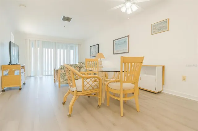 a dining room with furniture and a chandelier