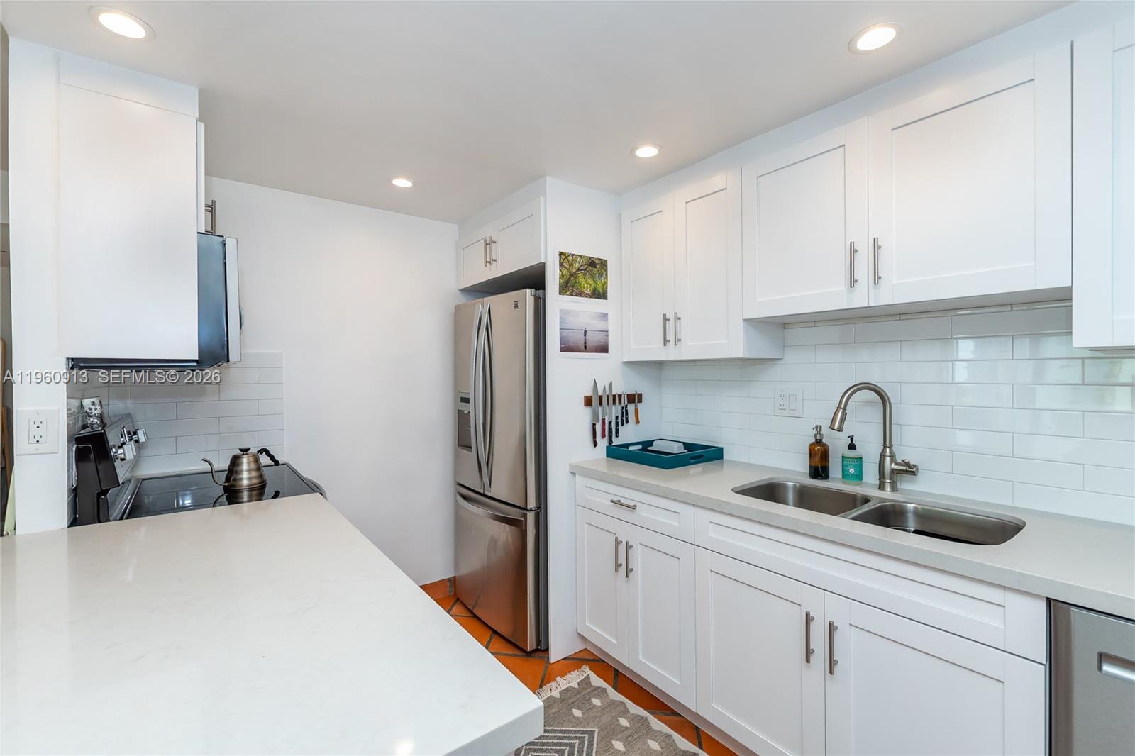 2451 Brickell Avenue, Unit 10K Miami, FL 33129 - Photo 11 of 25 a kitchen with refrigerator a sink and cabinets