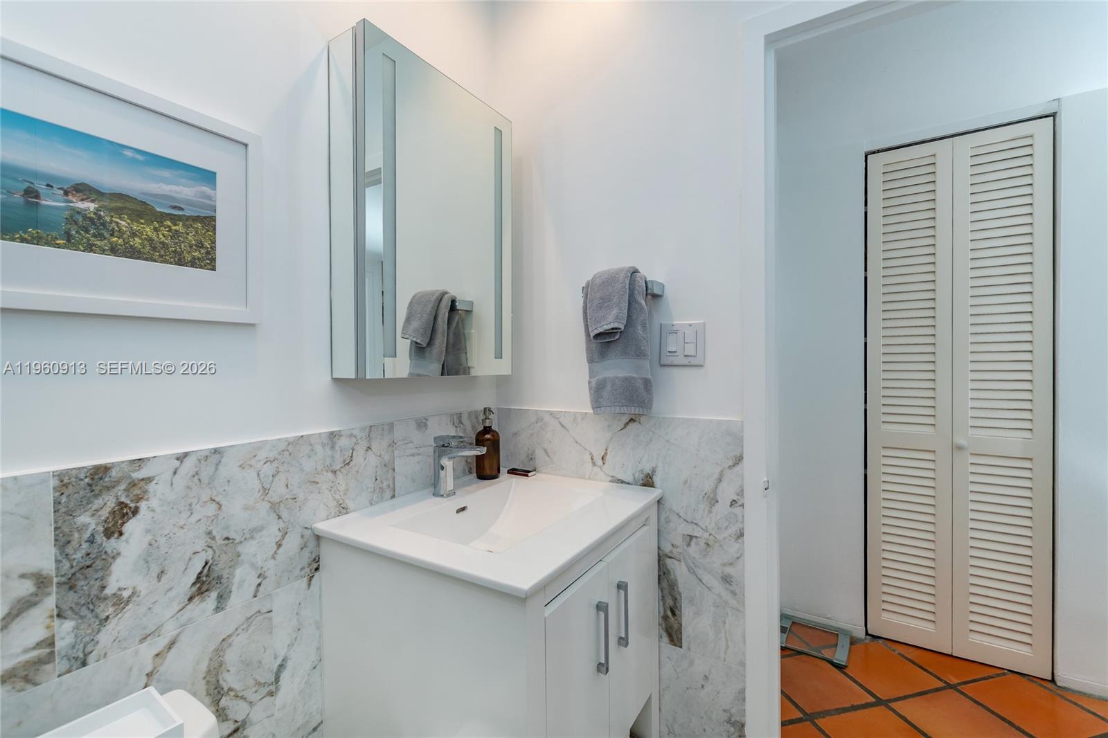 2451 Brickell Avenue, Unit 10K Miami, FL 33129 - Photo 14 of 25 a bathroom with a sink and a mirror
