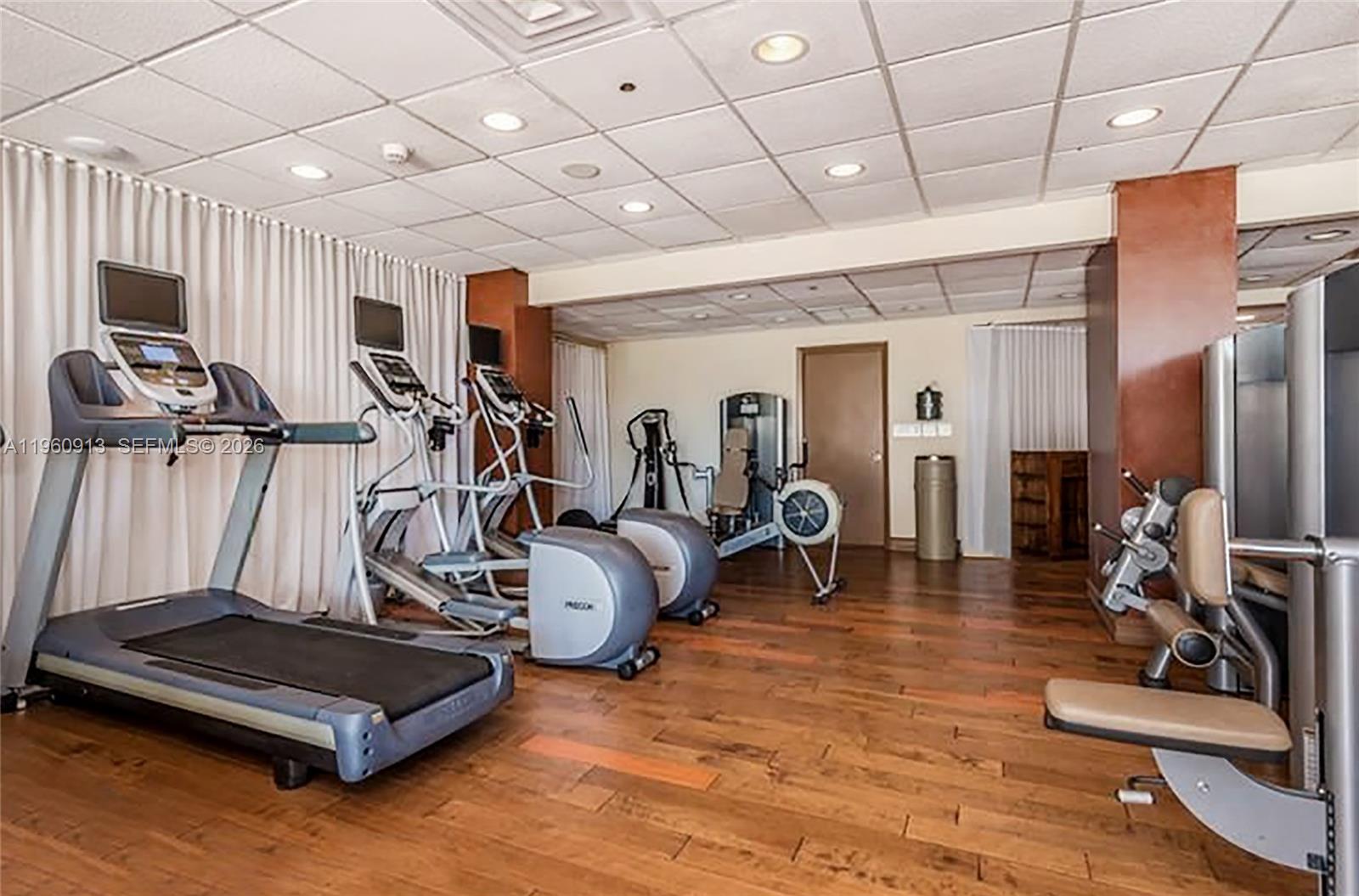 2451 Brickell Avenue, Unit 10K Miami, FL 33129 - Photo 25 of 25 a room with gym equipment and a large mirror