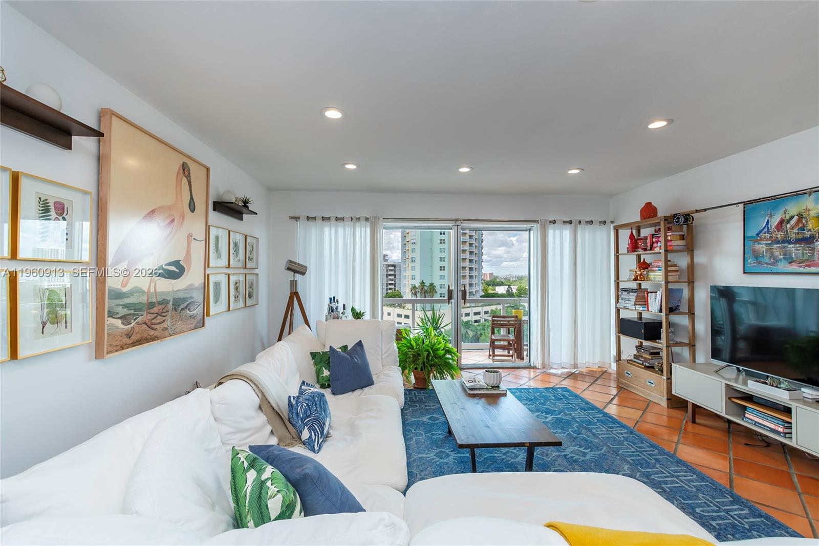 2451 Brickell Avenue, Unit 10K Miami, FL 33129 - Photo 6 of 25 a living room with furniture flat screen tv and a large window