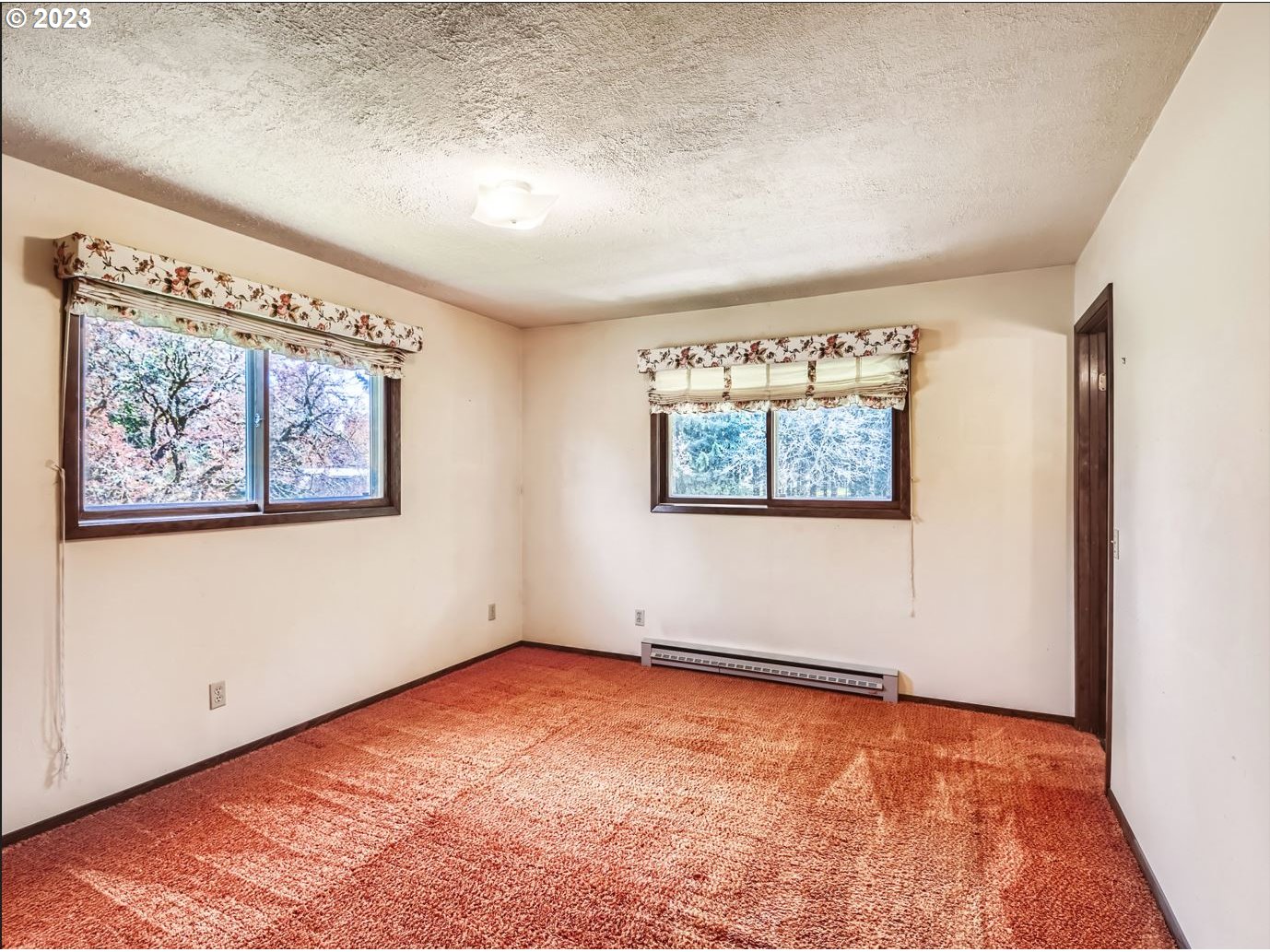 18331 Northwest Reeder Road Portland, OR 97231 - Photo 23 of 46 an empty room with wall painting and wooden floor