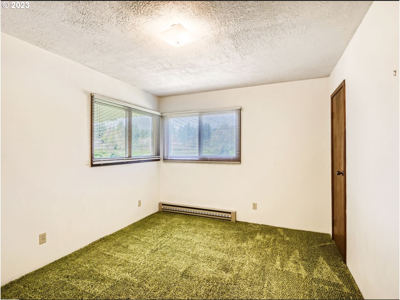 18331 Northwest Reeder Road Portland, OR 97231 - Photo 25 of 46 a view of a room with wooden floor and window