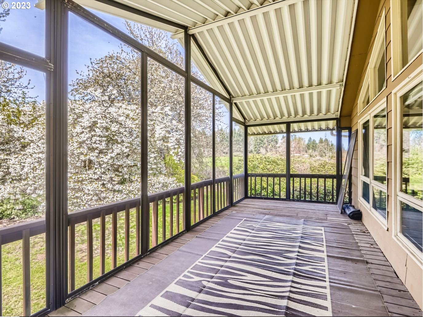 18331 Northwest Reeder Road Portland, OR 97231 - Photo 34 of 46 a view of a porch with wooden floor and stairs