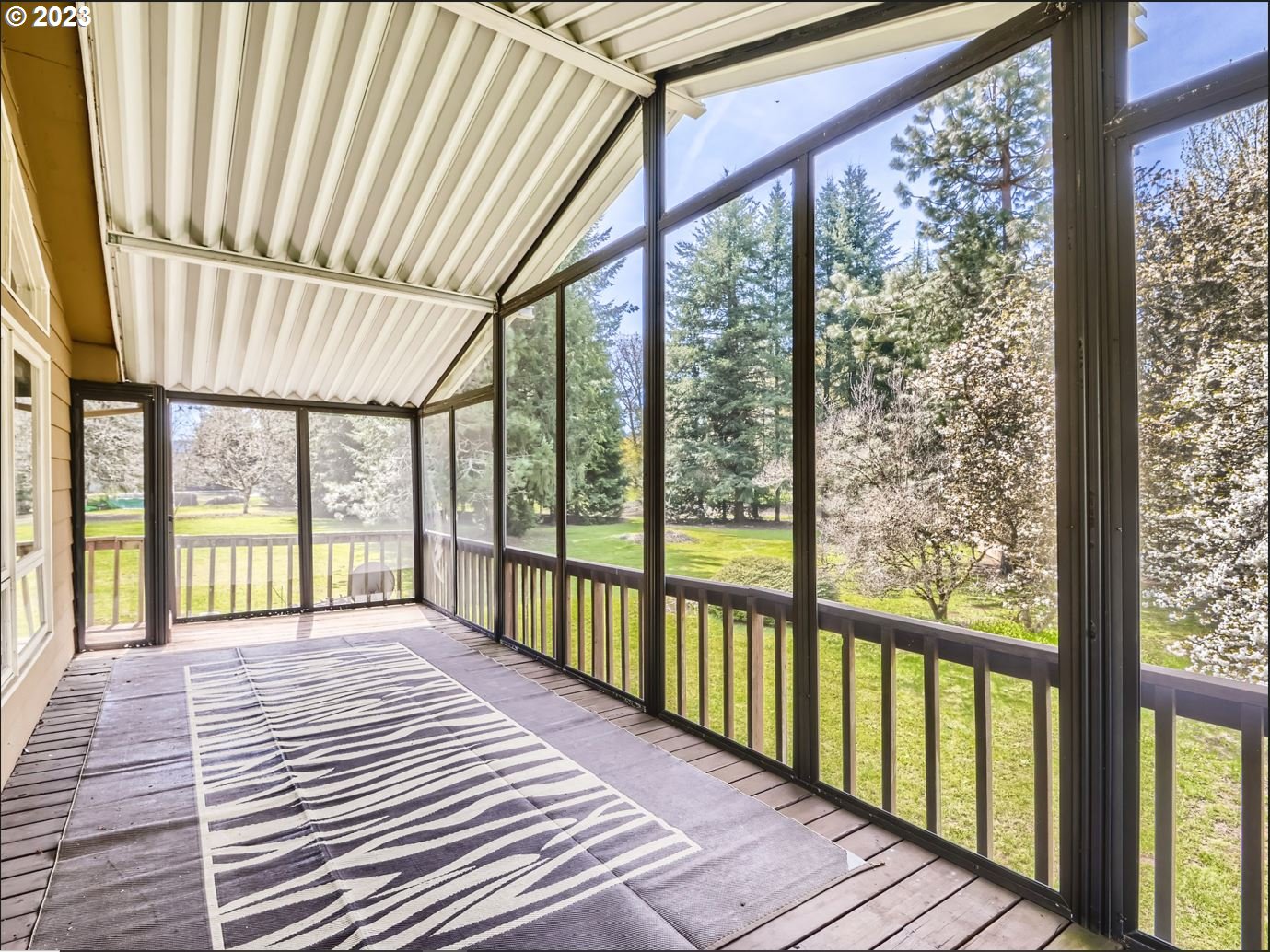 18331 Northwest Reeder Road Portland, OR 97231 - Photo 35 of 46 a view of a porch with wooden floor and outdoor space