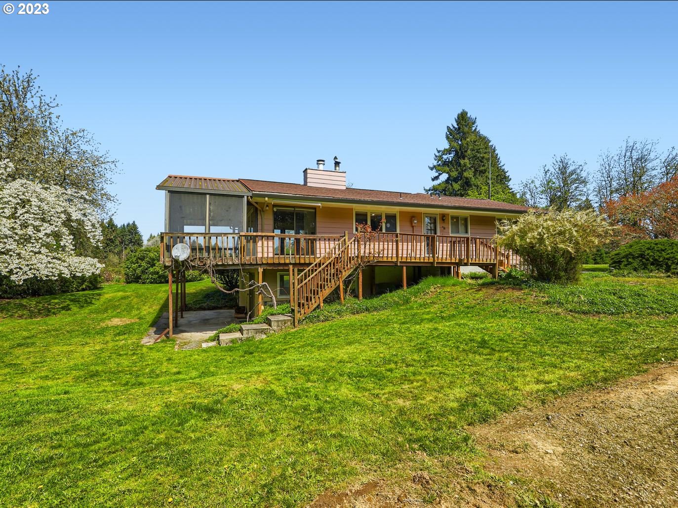 18331 Northwest Reeder Road Portland, OR 97231 - Photo 36 of 46 a view of a house with a yard porch and sitting area
