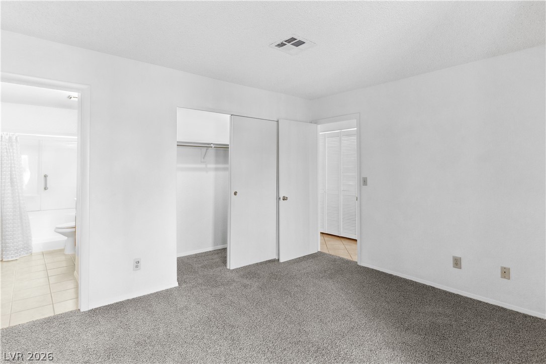 2146 High Dunes Lane Laughlin, NV 89029 - Photo 24 of 64 Primary bedroom featuring light colored carpet, and light tile patterned floors