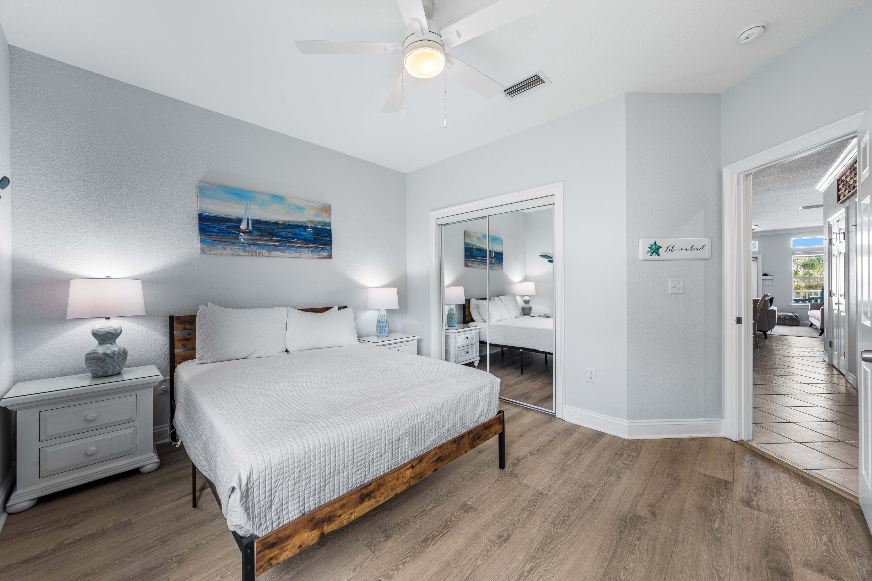 33 Dune Breeze Lane, Unit H2 Santa Rosa Beach, FL 32459 - Photo 34 of 54 a bedroom with a bed and wooden floor