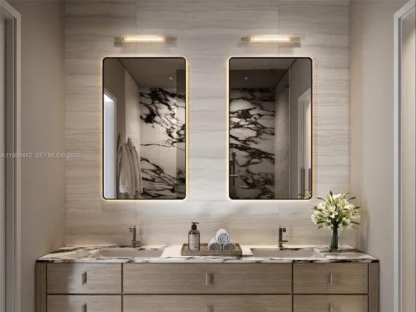 a bathroom with double vanity sinks and two mirror