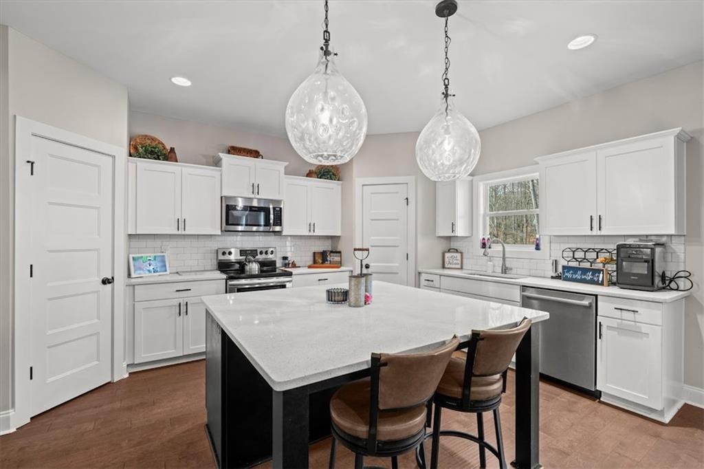 14 Cambridge Lane Bremen, GA 30110 - Photo 13 of 51 a kitchen with stainless steel appliances a table chairs and cabinets