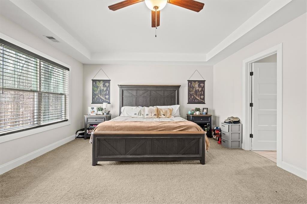14 Cambridge Lane Bremen, GA 30110 - Photo 23 of 51 a spacious bedroom with a bed and a chandelier