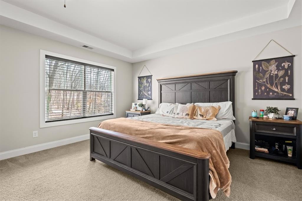 14 Cambridge Lane Bremen, GA 30110 - Photo 24 of 51 a spacious bedroom with a bed a dresser and next to a window
