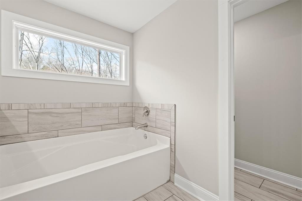 14 Cambridge Lane Bremen, GA 30110 - Photo 26 of 51 a white bath tub sitting next to a window