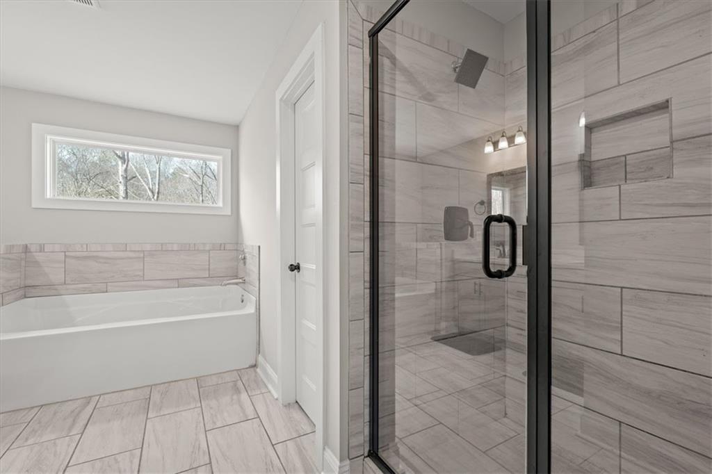 14 Cambridge Lane Bremen, GA 30110 - Photo 29 of 51 a bathroom with a bathtub and shower