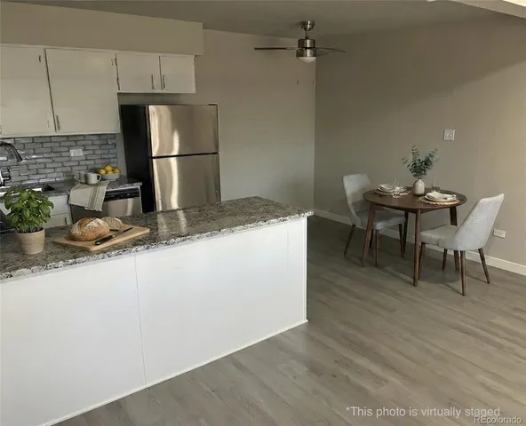a kitchen with a sink cabinets and wooden floor