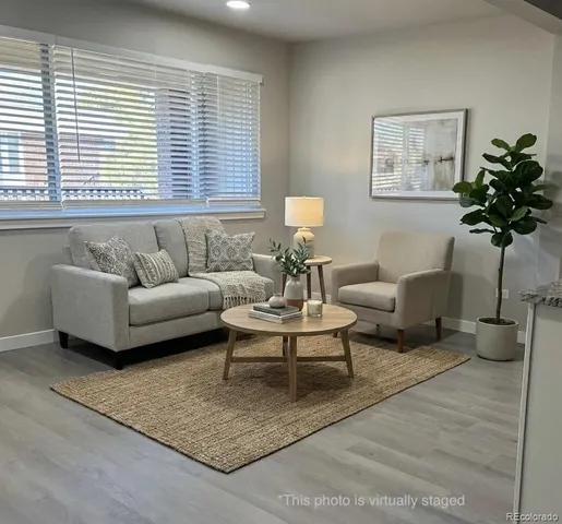 a living room with furniture and a potted plant