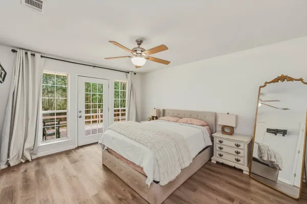 a bedroom with a large bed and a window
