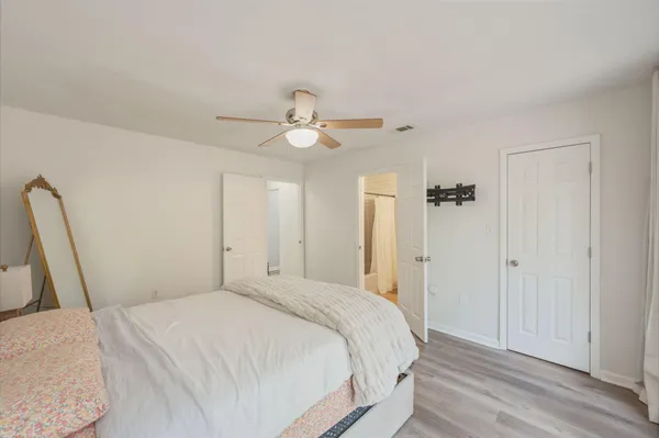 a bedroom with a bed and a ceiling fan