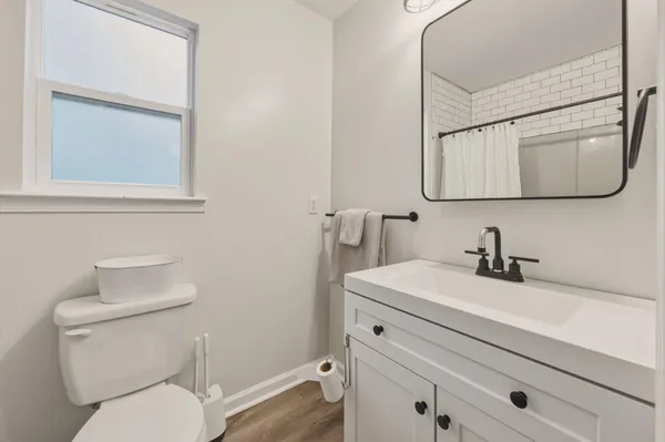 a bathroom with a toilet sink and mirror