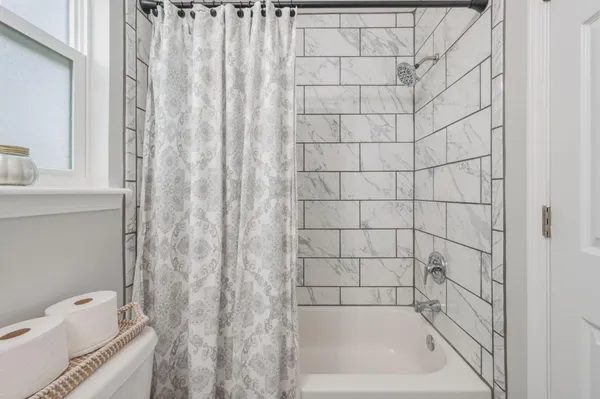 a bathroom with a bathtub and shower
