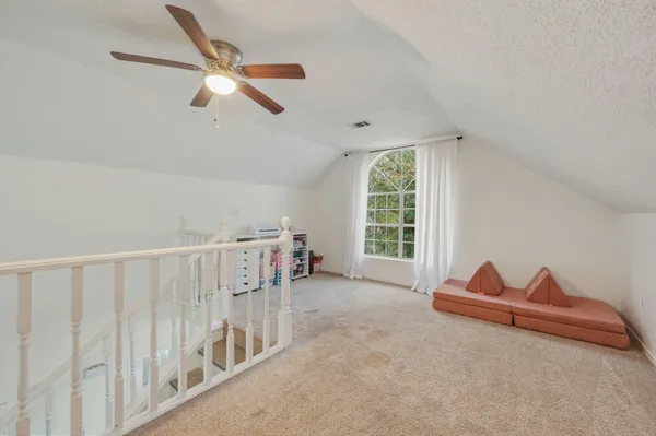 a view of room with wooden floor and windows