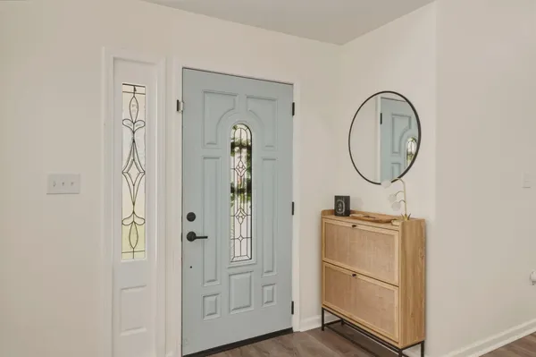 a front view of a bathroom with mirror gate and wooden floor