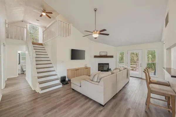 a living room with furniture and a wooden floor