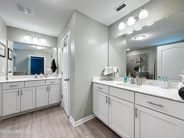 a bathroom with a double vanity sink and a mirror