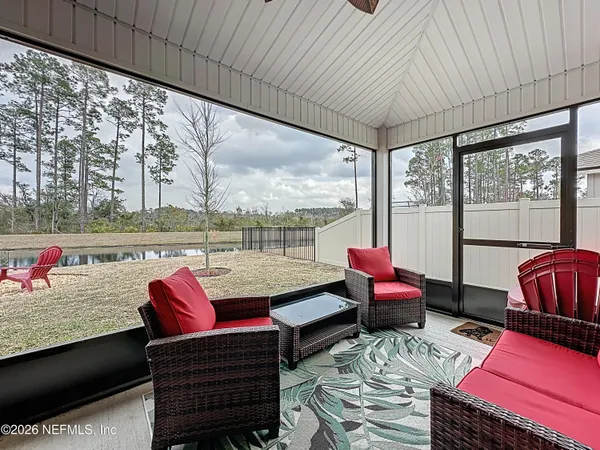 a living room with furniture and a floor to ceiling window