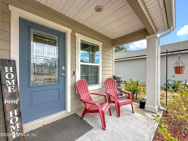 a view of a house with a chairs and table in a patio