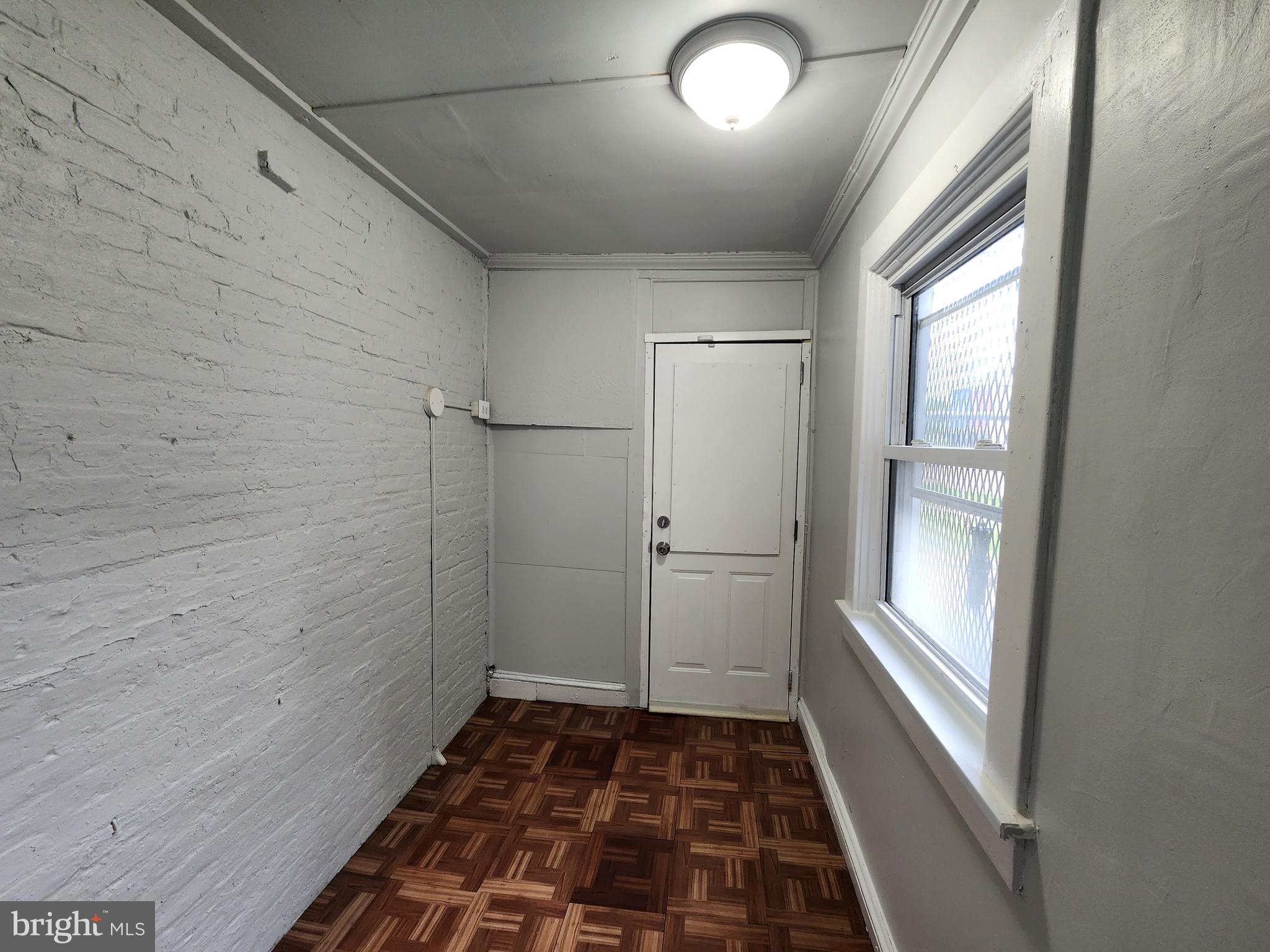 2014 East Lanvale Street Baltimore, MD 21213 - Photo 12 of 32 a bathroom with a glass door shower and a window