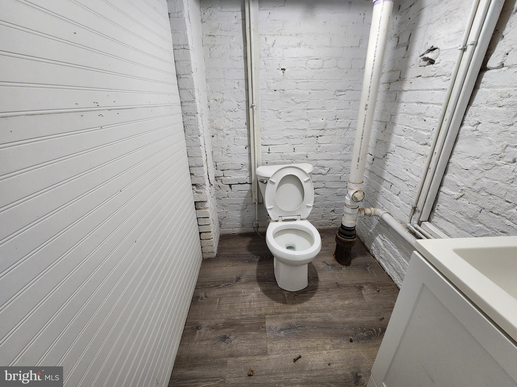 2014 East Lanvale Street Baltimore, MD 21213 - Photo 21 of 32 a white toilet sitting next to a bathroom sink
