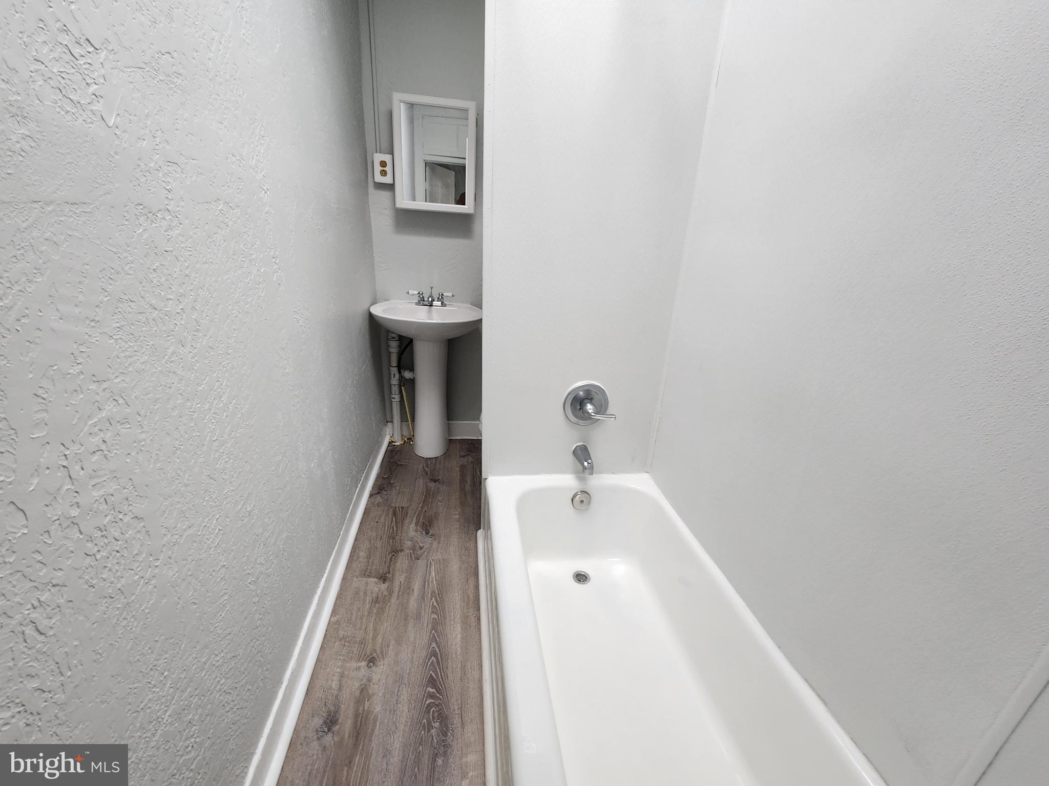 2014 East Lanvale Street Baltimore, MD 21213 - Photo 24 of 32 a bathroom with a tub sink and mirror