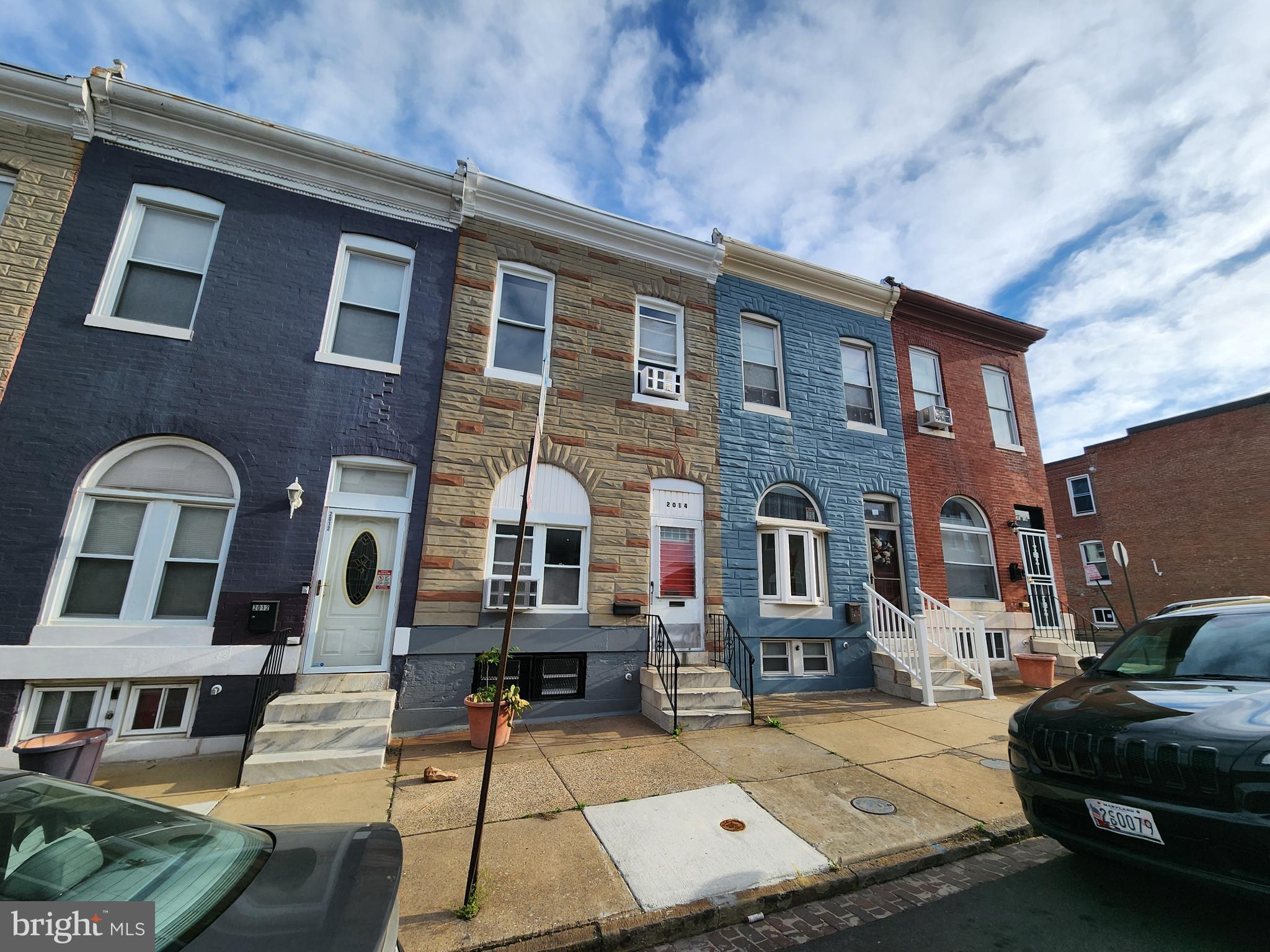 2014 East Lanvale Street Baltimore, MD 21213 - Photo 4 of 32 a front view of a residential apartment building with a yard