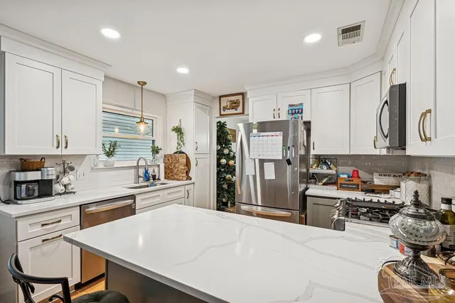 a kitchen with a refrigerator and a sink
