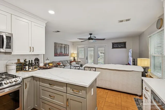 a kitchen with a stove a sink and a refrigerator