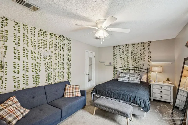 a bedroom with a bed and a couch