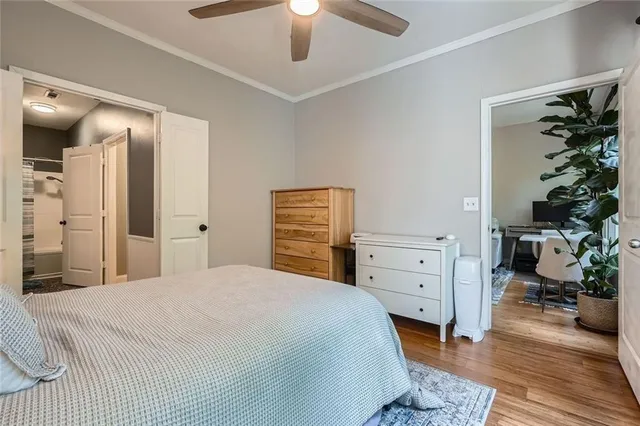 a bedroom with a bed and a potted plant