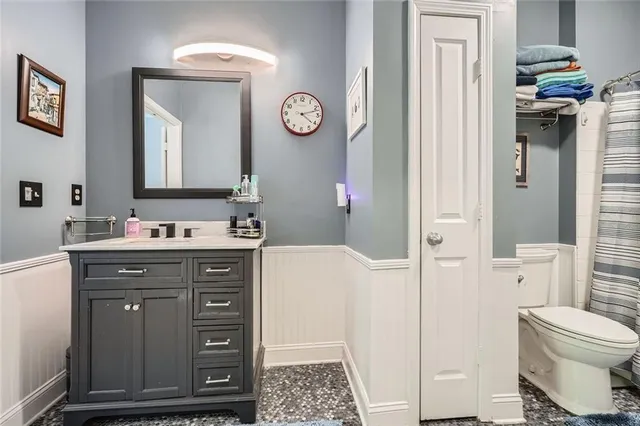 a spacious bathroom with a sink a toilet and a mirror