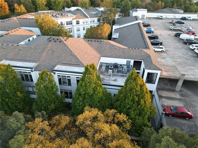 an aerial view of multiple houses with a yard