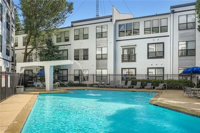 a front view of building with yard and lots of green space