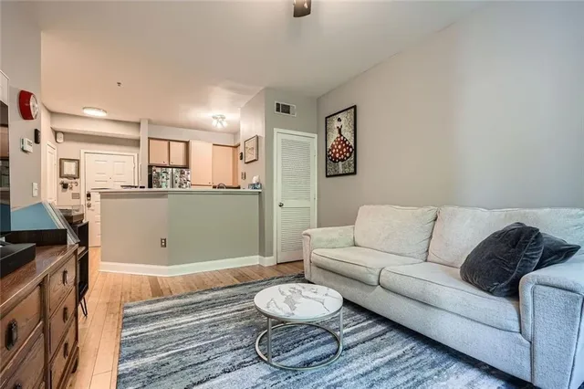 a living room with granite countertop furniture and a wooden floor