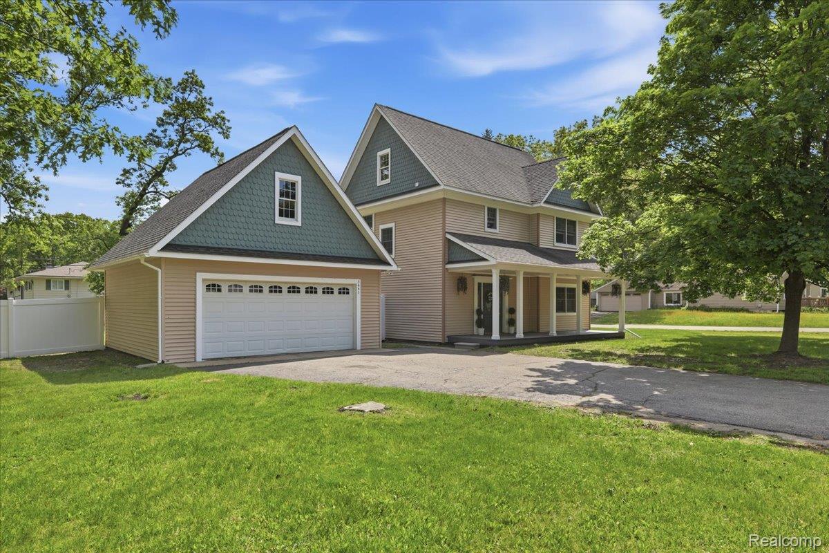 5685 Crescent Road Waterford, MI 48327 - Photo 2 of 47 Two-story home with a tan siding exterior and a covered porch with white pillars