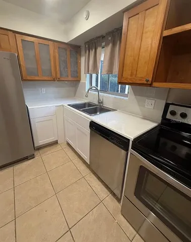 a kitchen with a sink cabinets and appliances