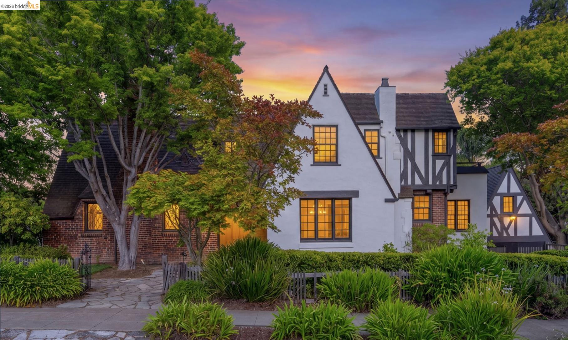 1087 Hubert Road Oakland, CA 94610 - Photo 1 of 67 Stucco and half-timbered Tudor Revival exterior featuring a steep gabled roof, multi-pane windows, and a brick accent section